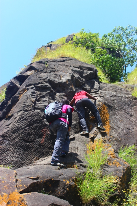 Trek leader Yamini assisting fellow trekkers climb the final incline before the cave comes in sight